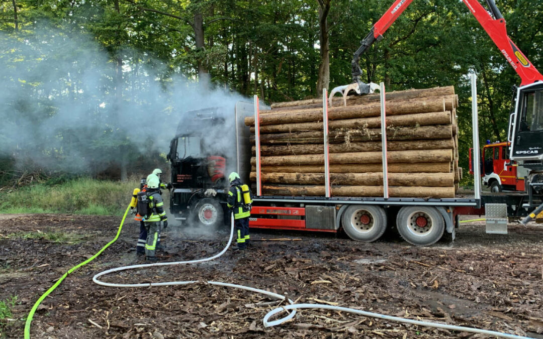 LKW gerät auf Holzverladeplatz in Brand